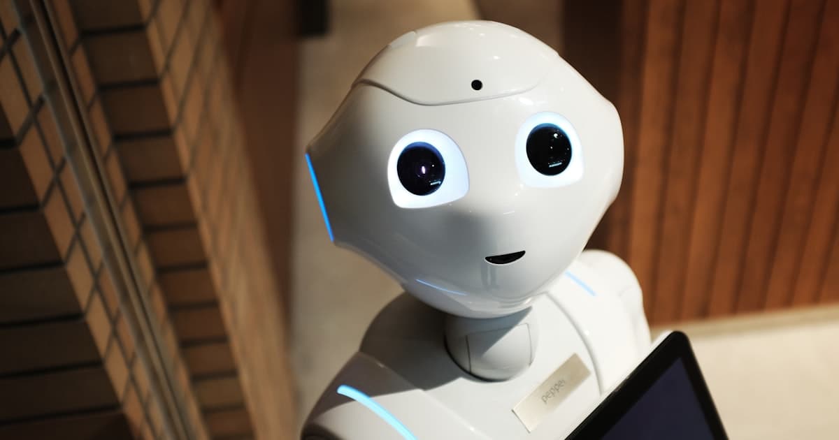 Humanoid service robot holding a tablet, illustrating AI-driven automation